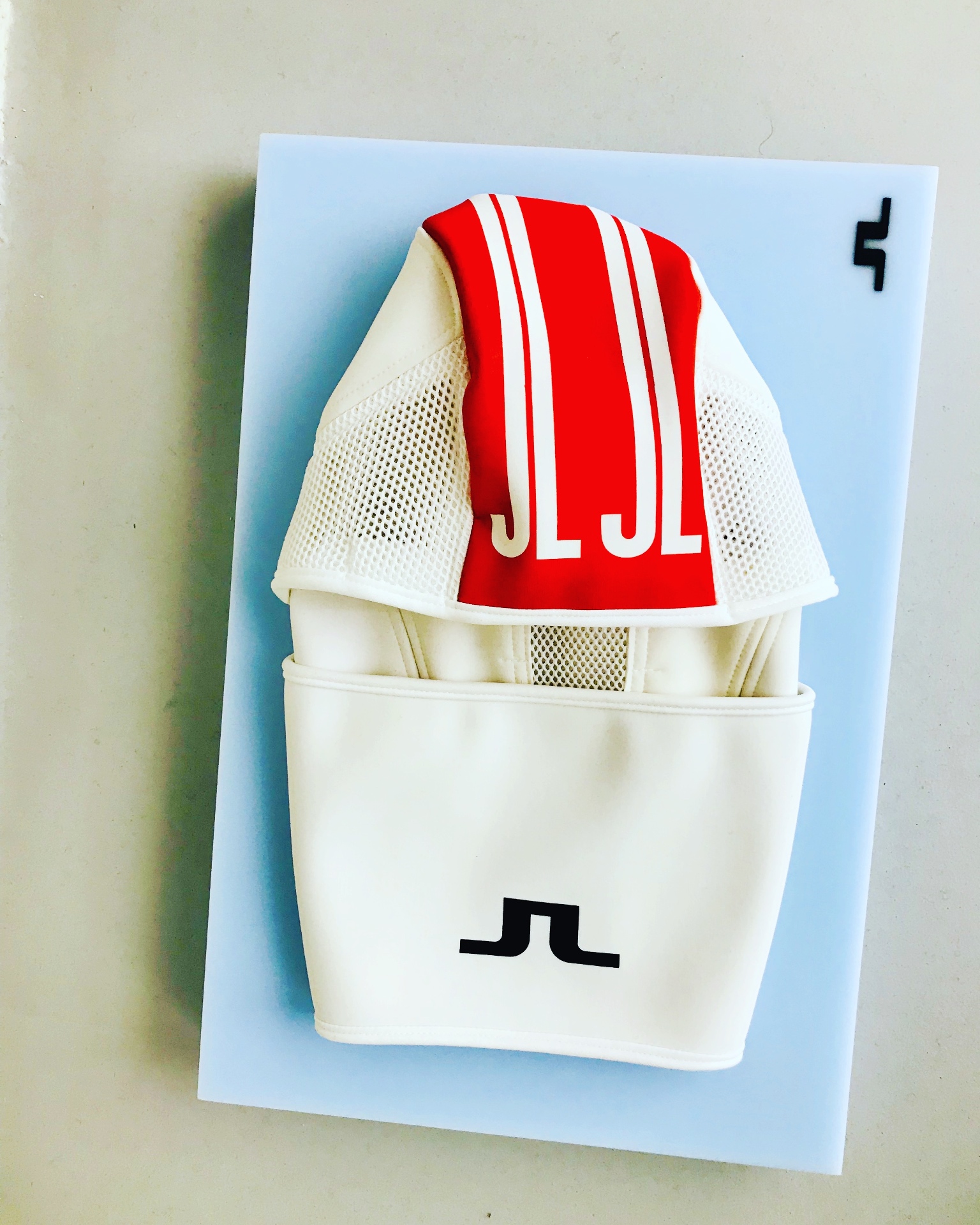 J.Lindeberg red and white JL monogram jacket, product flatlay on light-blue board